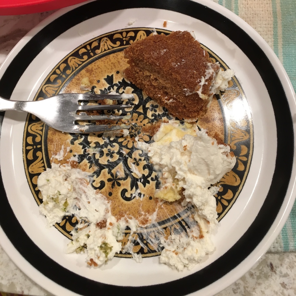 The remnants of a mostly-eaten pie slice on a plate. The crust is overturned.